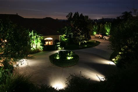 Parking lighting Pathway lighted with bright spot lights positioned within surrounding garden ...