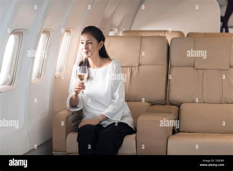 Elegant Mature Woman Drinking Wine On Airplane Stock Photo Alamy