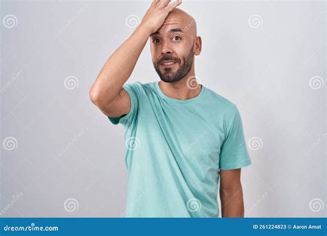 Middle Age Bald Man Standing Over White Background Surprised With Hand On Head For Mistake