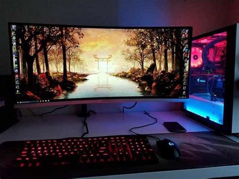 Two Computer Monitors Sitting On Top Of A Desk Next To A Keyboard And Monitor Screen