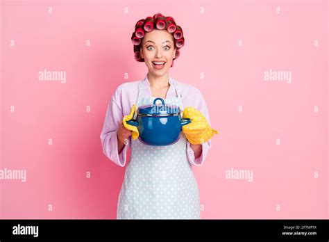 Photo Of Surprised House Wife Wear Dotted Blue Apron Red Rollers