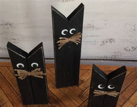 Three Black Wooden Sticks With Eyes And Noses Tied To Each Other On A