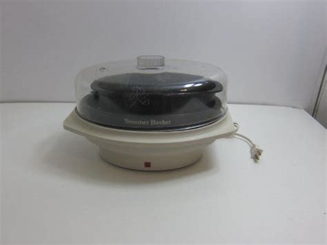 An Electronic Device Is Sitting On Top Of A White Table With A Glass