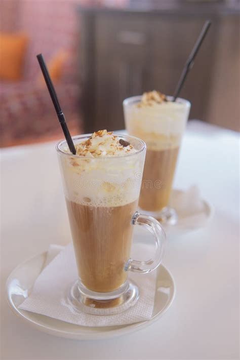 Coffee Is Served In A Tall Glass Glass With A Straw The Concept Of