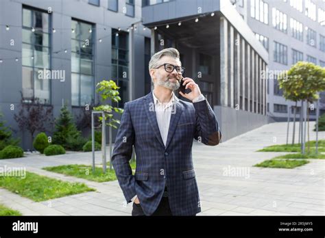 Successful Mature Gray Haired Man Talking On The Phone Senior
