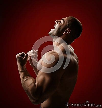 Screaming Strong Muscular Man Bodybuilder Stands With Naked Chest