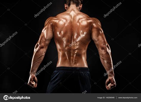 Back View Of Unrecognizable Man Strong Muscles Posing With Arms Down