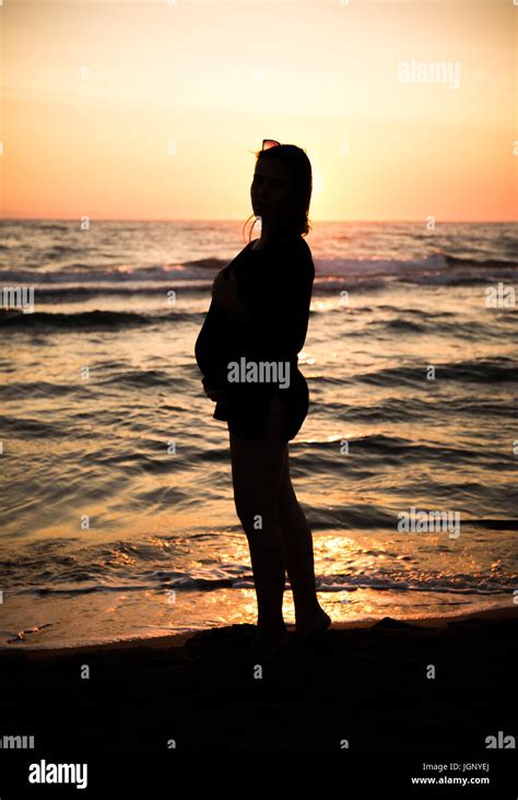 silhouette of a pregnant woman at sunset Stock Photo - Alamy