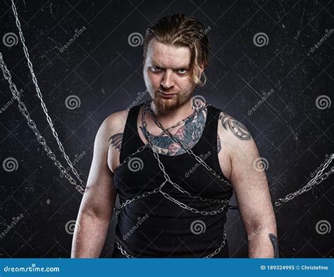 Photo Of A Tattooed Young Blond Man Bound In Chains Stock Image Image