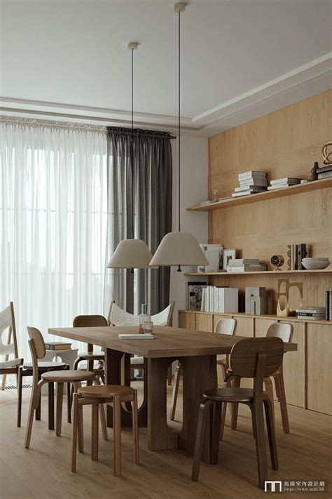 A Dining Room Table And Chairs In Front Of A Bookshelf Filled With Books