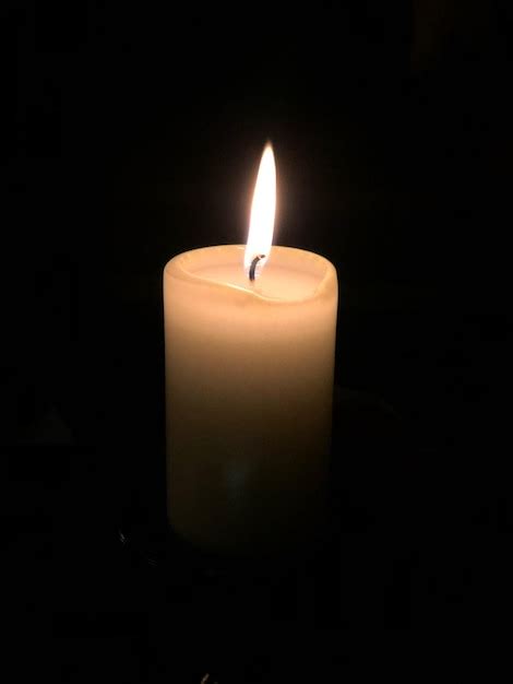 Premium Photo Close Up Of Lit Candle Against Black Background