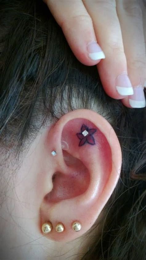 Tiny Flower Tattoo In The Ear With A Peircing Abby This Is A Must We Should Both Get A Flower