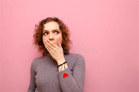 Emotional Curly Girl With Shocked Covered Face Looks Away To Empty