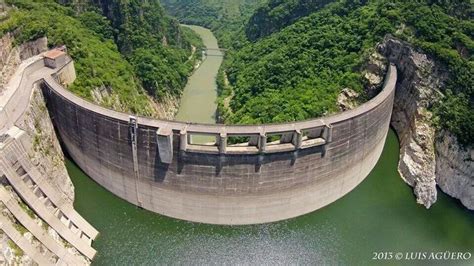 An Aerial View Of A Large Dam In The Middle Of A River Surrounded By