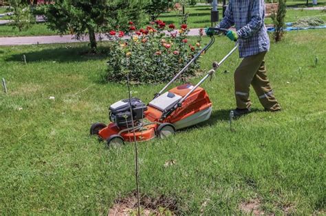 Premium Photo Banner Lawn Mower Man Mows The Grass In The Backyard