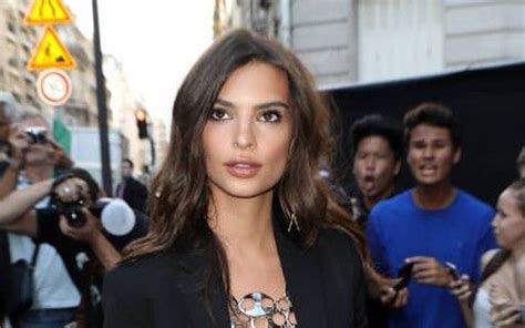 A Woman Standing In Front Of A Group Of People On The Street With