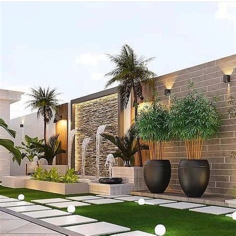 An Outdoor Courtyard With Grass And Potted Plants On The Ground