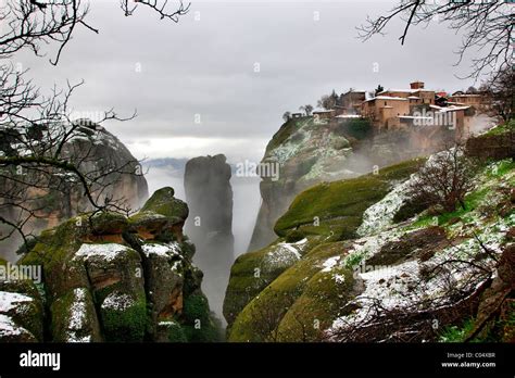 Greece, Meteora. Winter atmosphere with fog and snow. On the upper ...