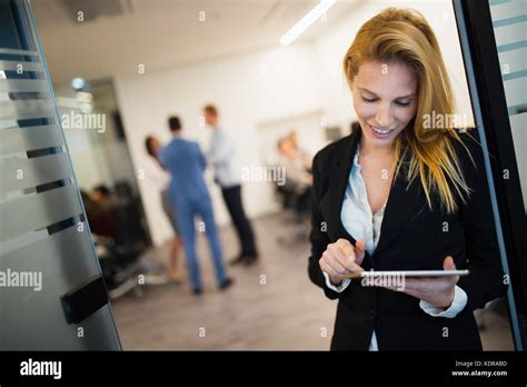 Portrait Of Beautiful Blonde Businesswoman Holding Tablet Stock Photo
