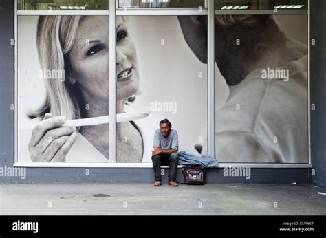 Middle Class Man Sitting In Front Of Supply Store Window Containing A