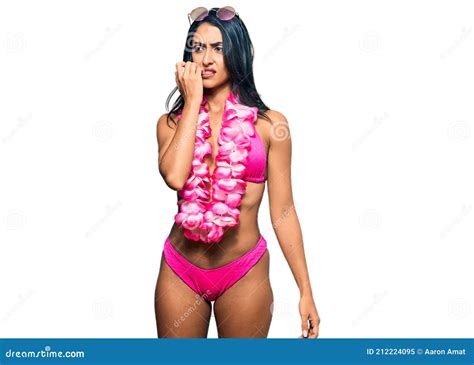 Beautiful Hispanic Woman Wearing Bikini And Hawaiian Lei Looking Stressed And Nervous With Hands
