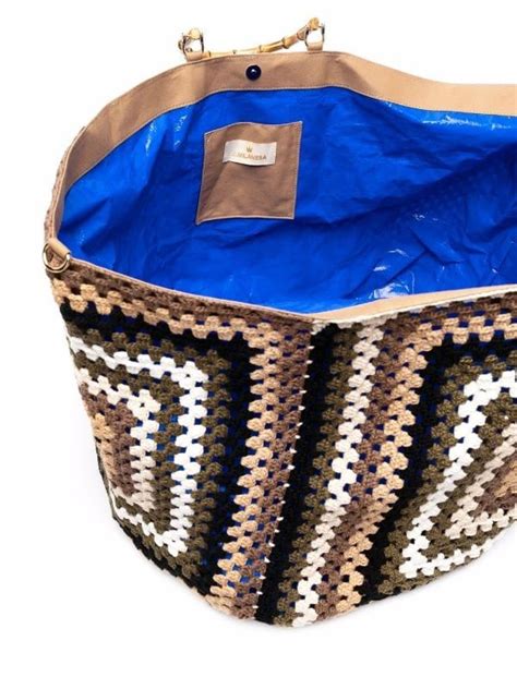 a blue and brown handbag on a white background