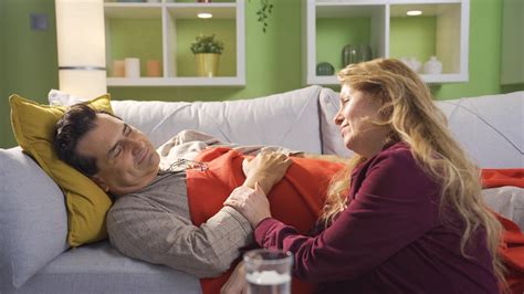 Loyal Woman Caring For Her Sick Husband Happy And Friendly Married