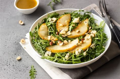 Premium Photo Arugula Gorgonzola Cheese Caramelized Pear And Nut Salad