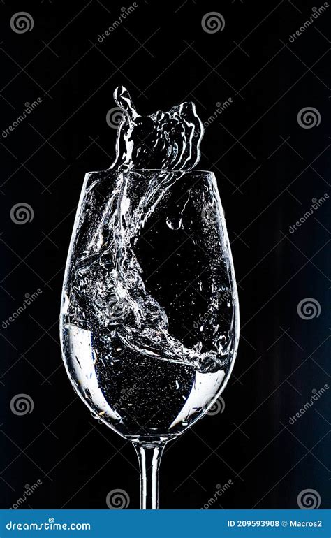 Water In A Glass On A Black Background With Splashes Is Very Beautifully Useful And Healthy