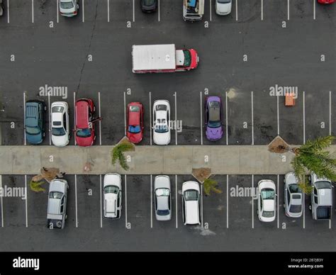 Aerial Top View Of Parking Lot At Supermarket With With Varieties Of