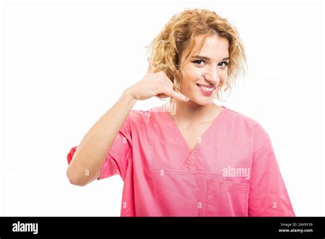 Portrait Of Nurse Wearing Pink Scrub Showing Calling Gesture Isolated