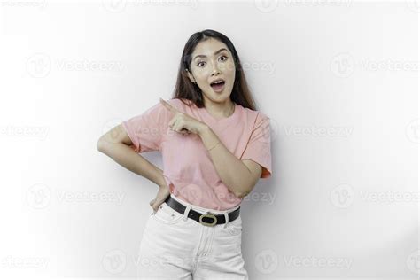 Shocked Asian Woman Wearing Pink T Shirt Pointing At The Copy Space On