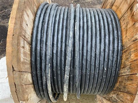 Large Spool With Black Thick Electrical Wire Or Cable Wooden Coil With