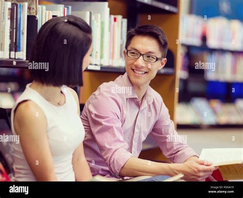 Two Young Students Working Together At The Library Stock Photo Alamy