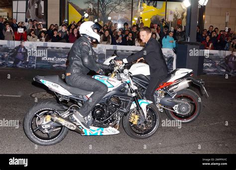 Jeremy Renner arrives on a motorcycle at the premiere of "The Bourne ...