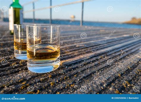 Drinking Single Malt Scotch Whisky At Sunset With Sea Ocean Or River