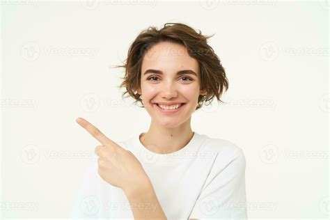 Close Up Shot Of Happy Candid Woman Laughing And Smiling Pointing Finger Left Showing