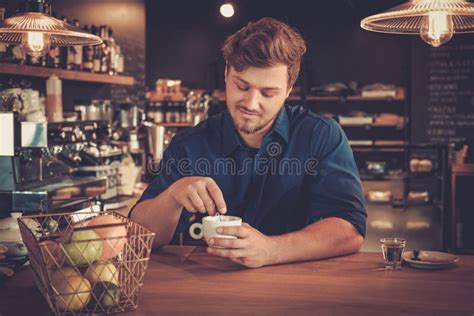 Handsome Barista Tasting A New Type Of Coffee In His Coffee Shop Stock