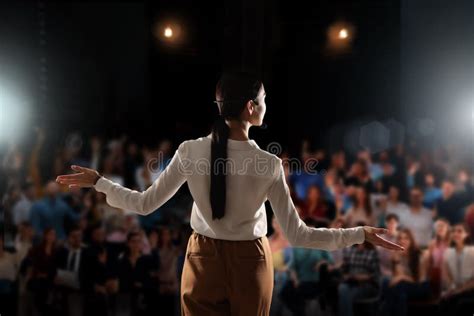 Motivational Speaker With Headset Performing On Stage Back View Stock