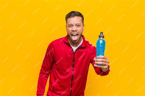 Premium Photo Young South Asian Sport Man Holding An Energy Drink