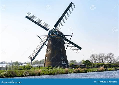 Traditional Dutch Wind Mill Built Along The Canal In North Holland