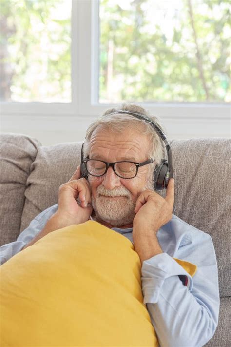 Senior Retirement Man Listen To Music Using Headphone Feeling Happy In