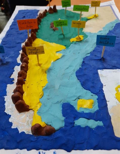 A Cake That Is Shaped Like The Map Of Europe With Flags And Name Tags On It