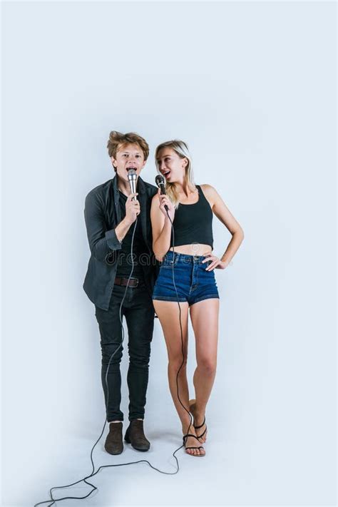 Happy Portrait Of Couple Holding Microphone And Sing A Song Stock Image