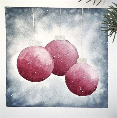 Three Pink Ornaments Hanging From A String On A White Wall Next To A