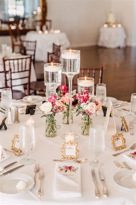 Glass Candlesticks With Floating Candles And Bud Vase Arrangements