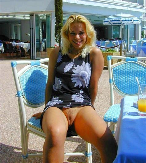 In A Short Dress In A Poolside Restaurant And Showing Her Pussy