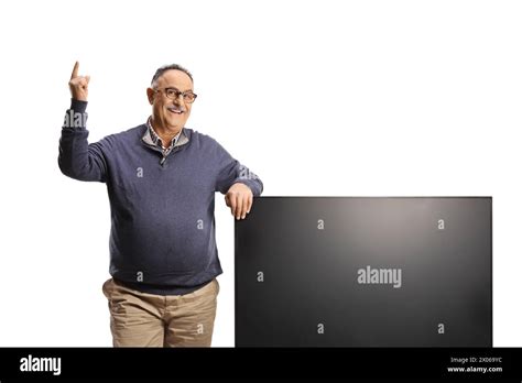 Mature Man Pointing Up And Leaning On A Tv Flat Hd Screen Isolated On