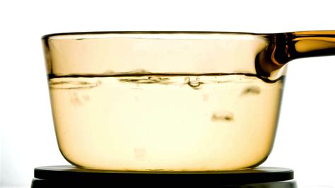 Captivating Heat Close Up Of Boiling Water In A Glass Pen Unveiling