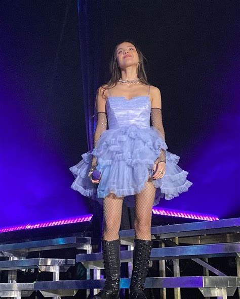 A Woman In A Blue Dress Standing On Stage